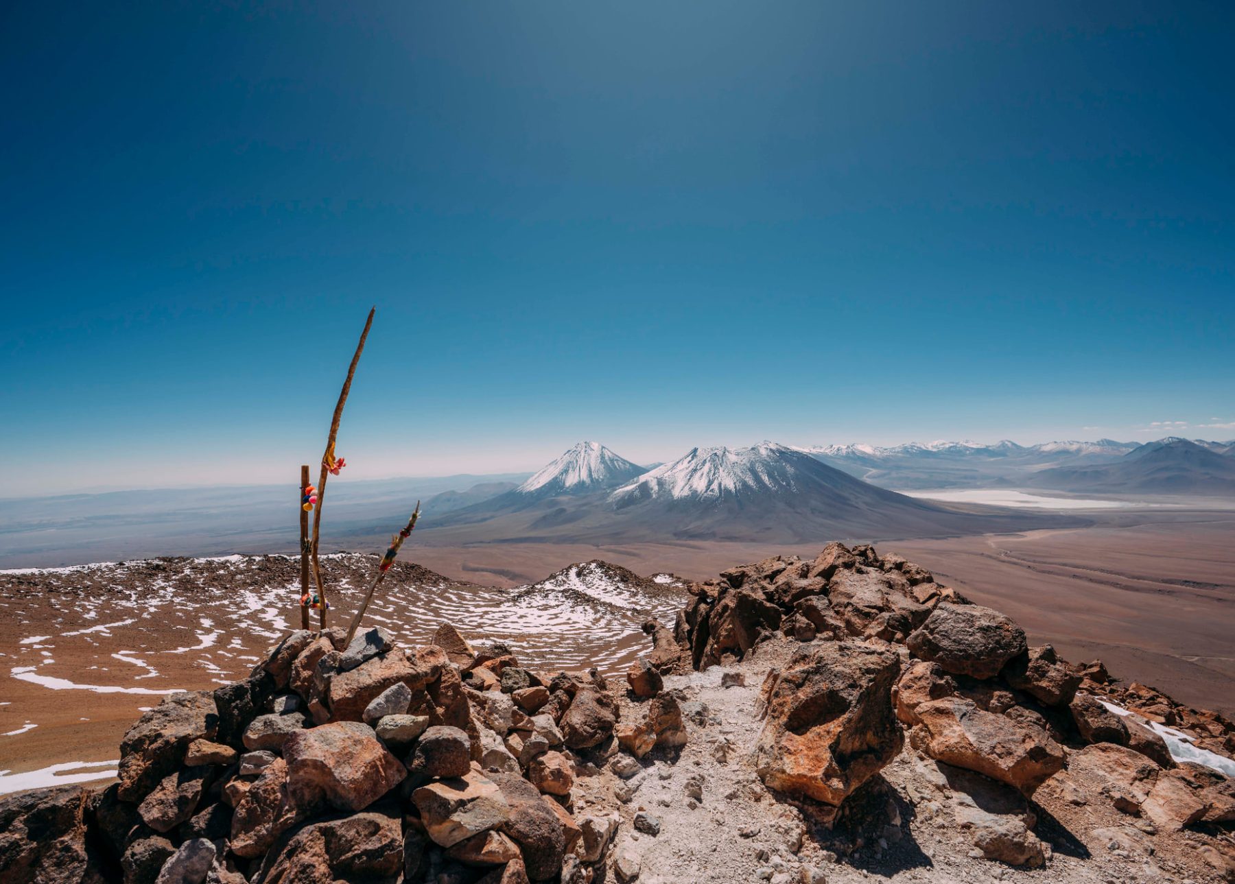 Cume de pedras com vista para os vulcões do Atacama